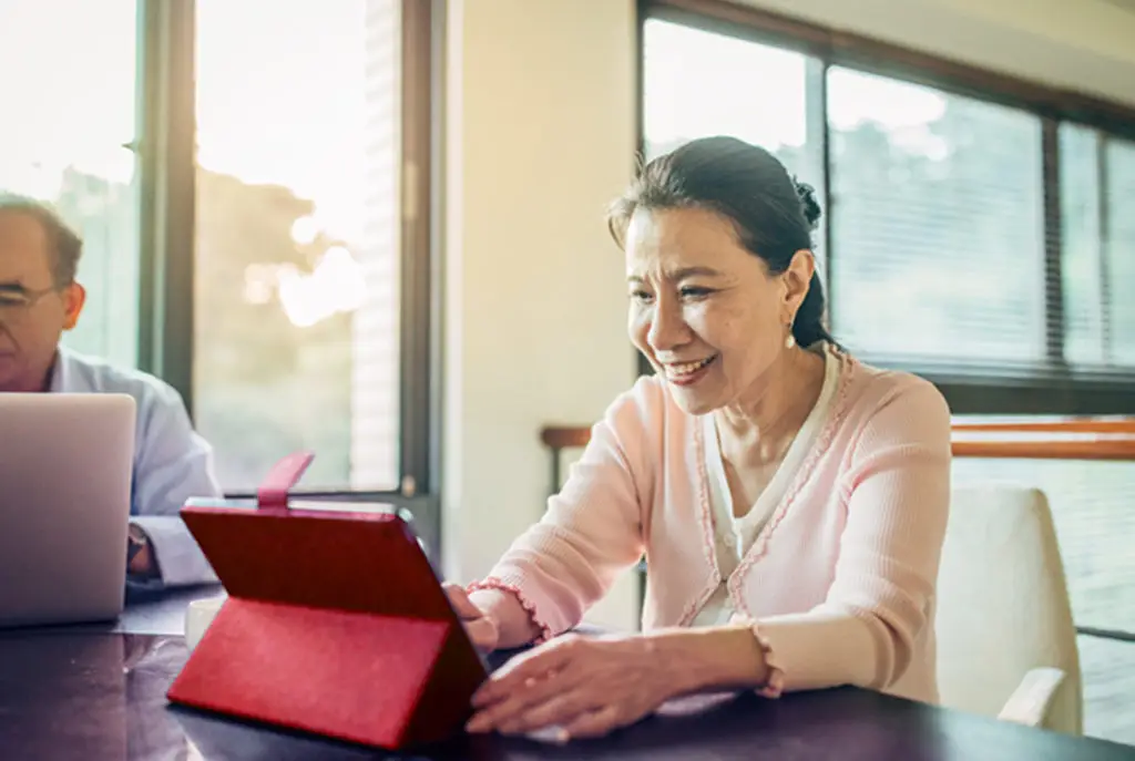 A senior couple using a laptop and digital tablet