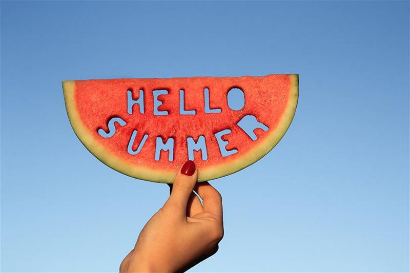 Watermelon with 'Hello Summer' cut out of it