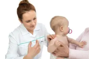 A healthcare professional vaccinating an infant