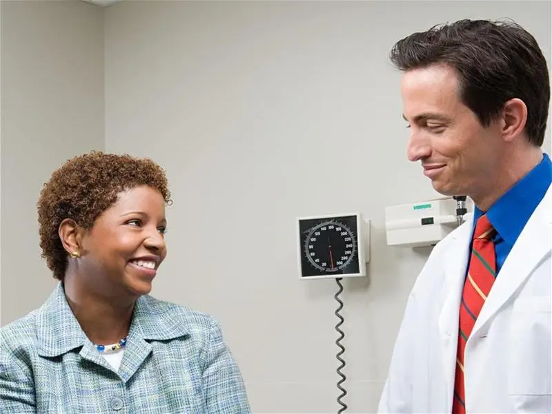 A physician consulting with patient in an exam room