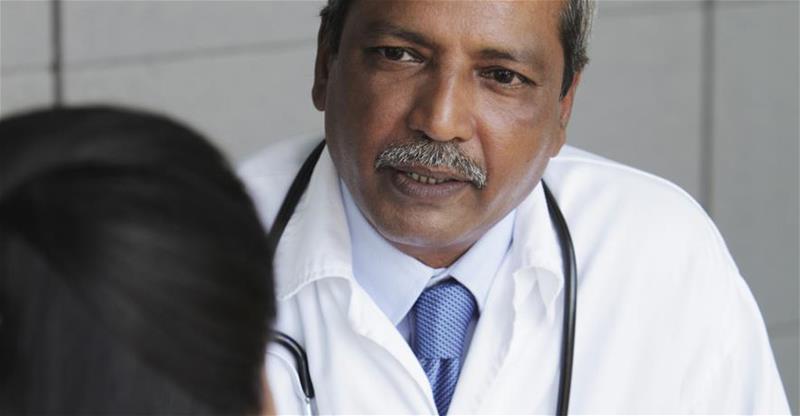 Male doctor consulting with patient