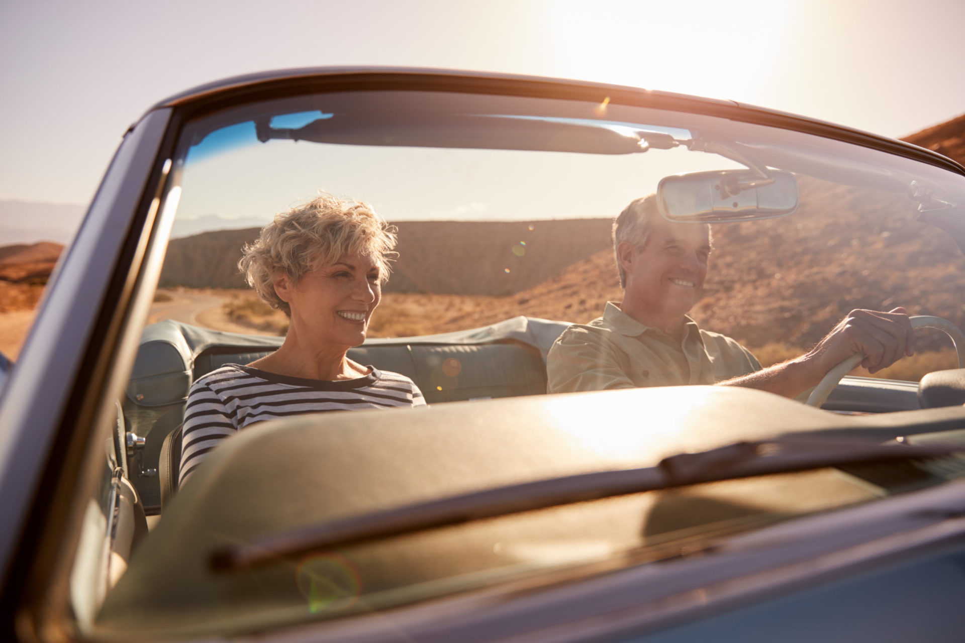 Couple in convertible driving on a country road