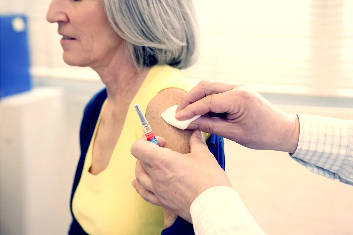A woman getting a vaccine shot in her arm