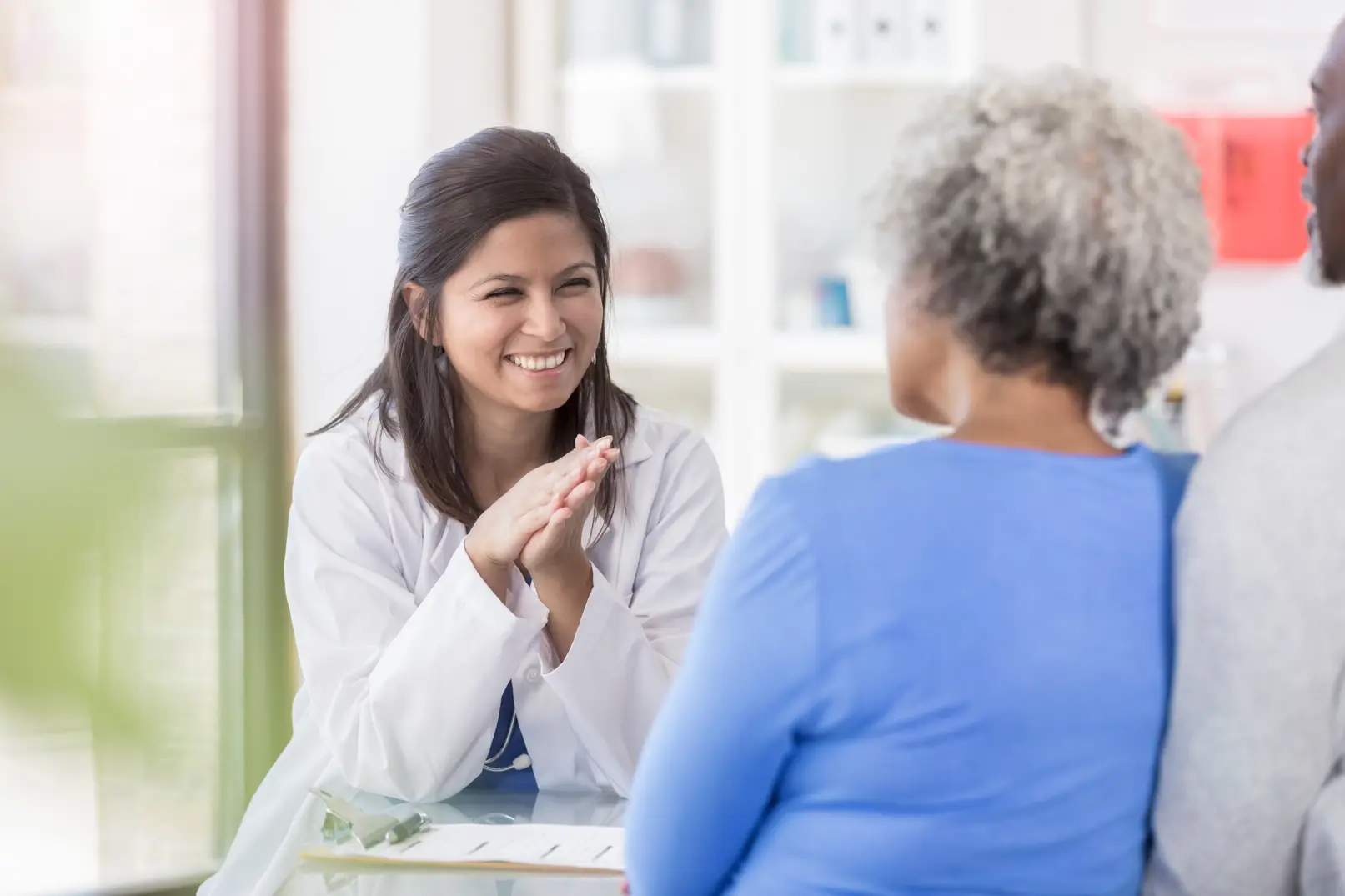 A doctor talking to an older couple