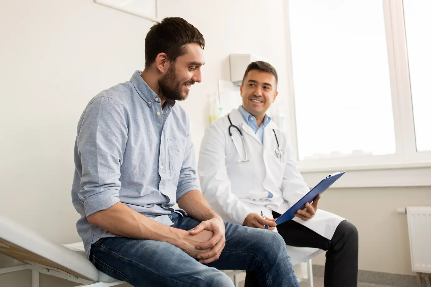 Doctor and patient talking in an exam room