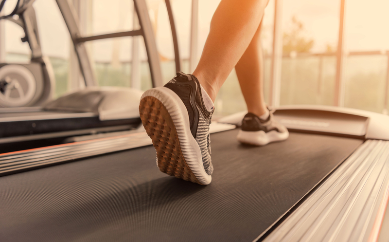 Woman's feet walking on treadmill