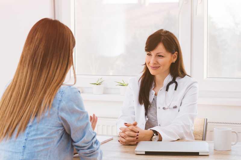 Doctor listens to her patient during a consultation
