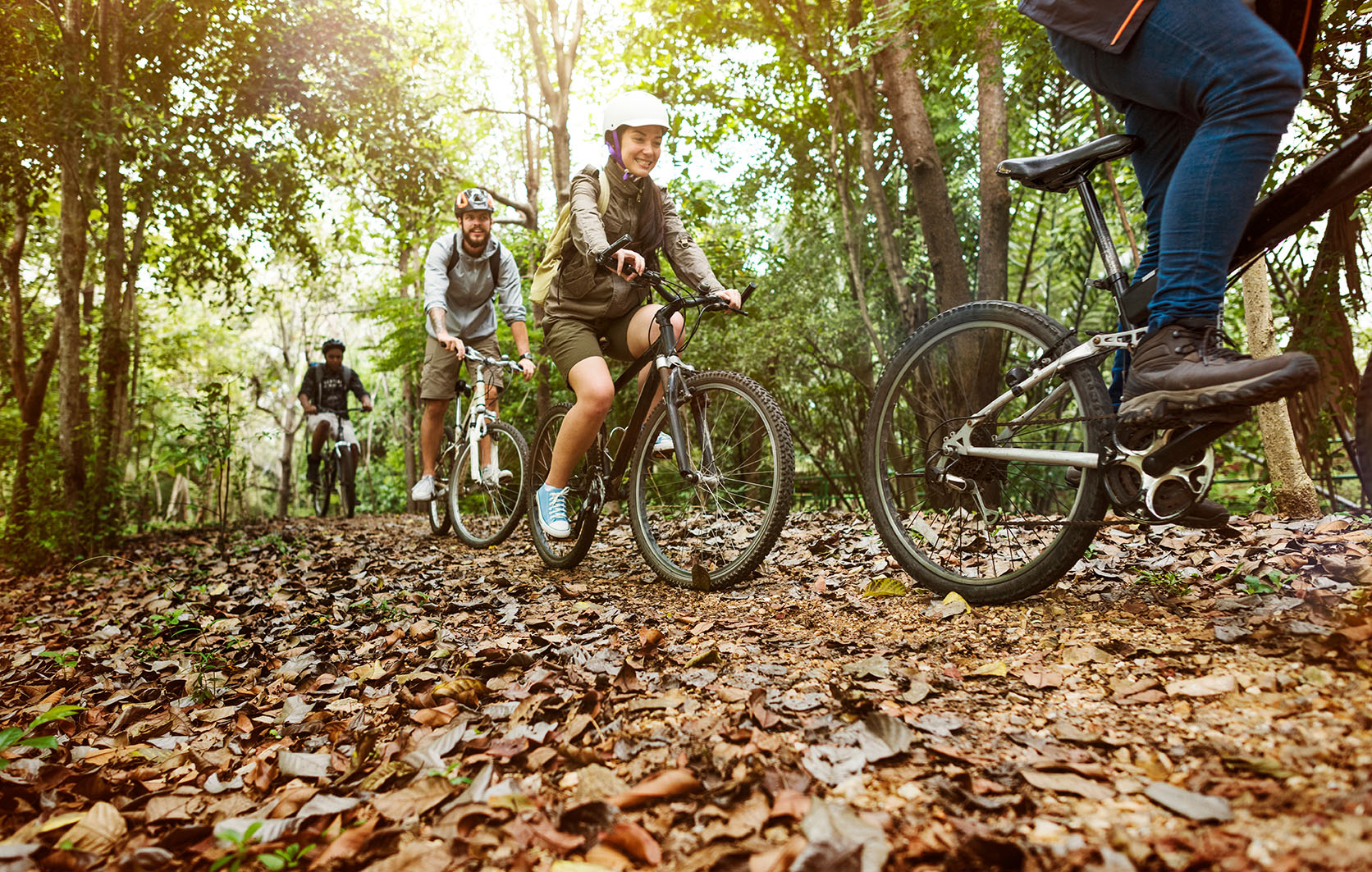 Group biking along a wooded path