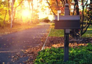 Mailbox with flag up on a quiet street on a sunny fall morning