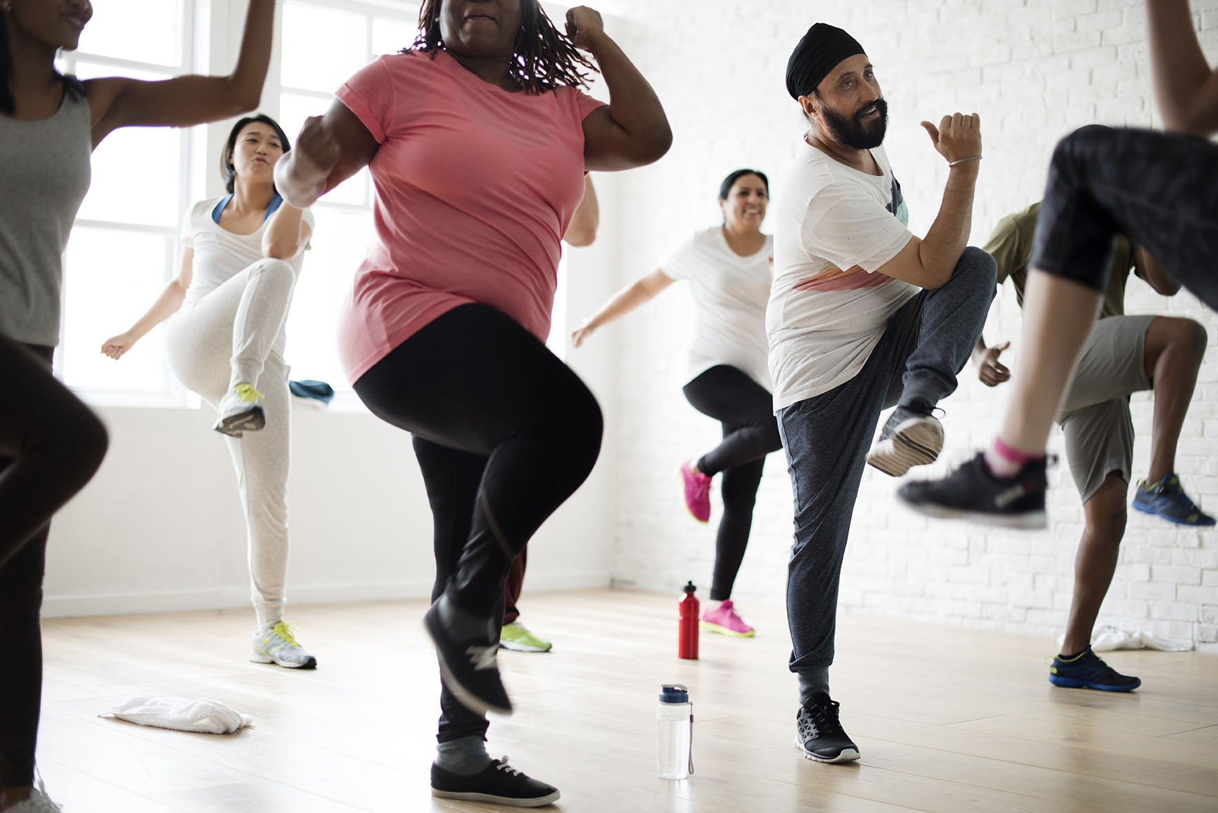 Diverse group of people exercise in a class together