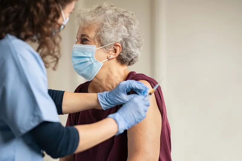 A senior woman getting vaccinated