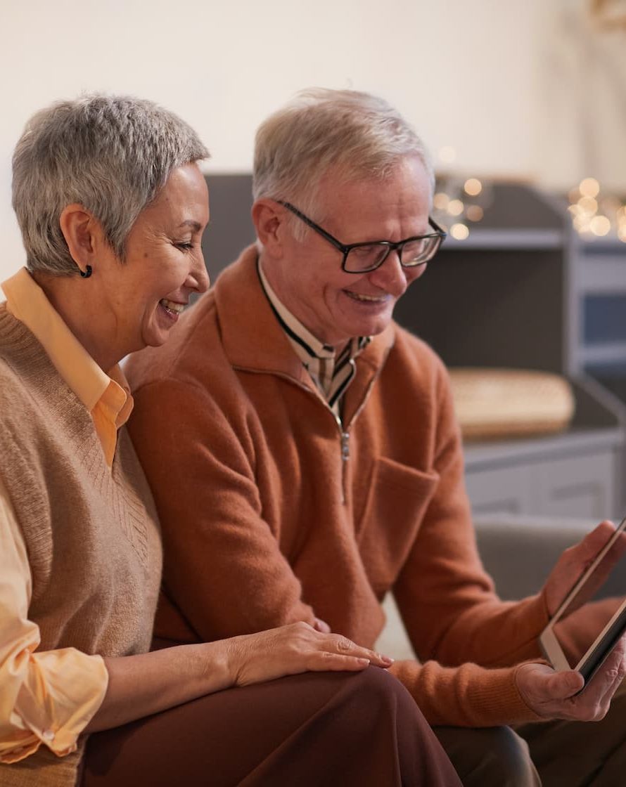 Senior woman and man looking at tablet
