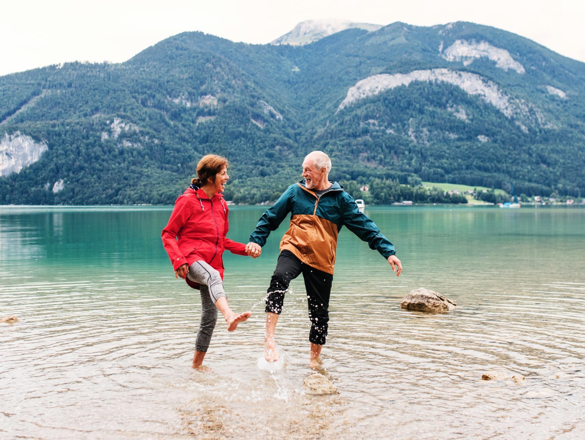 CoupleinLake_edit Senior couple splash around in the shallow part of a lake