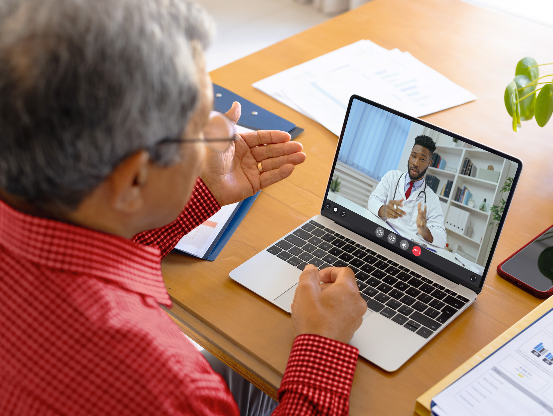 A senior man talking to a doctor during a virtual visit