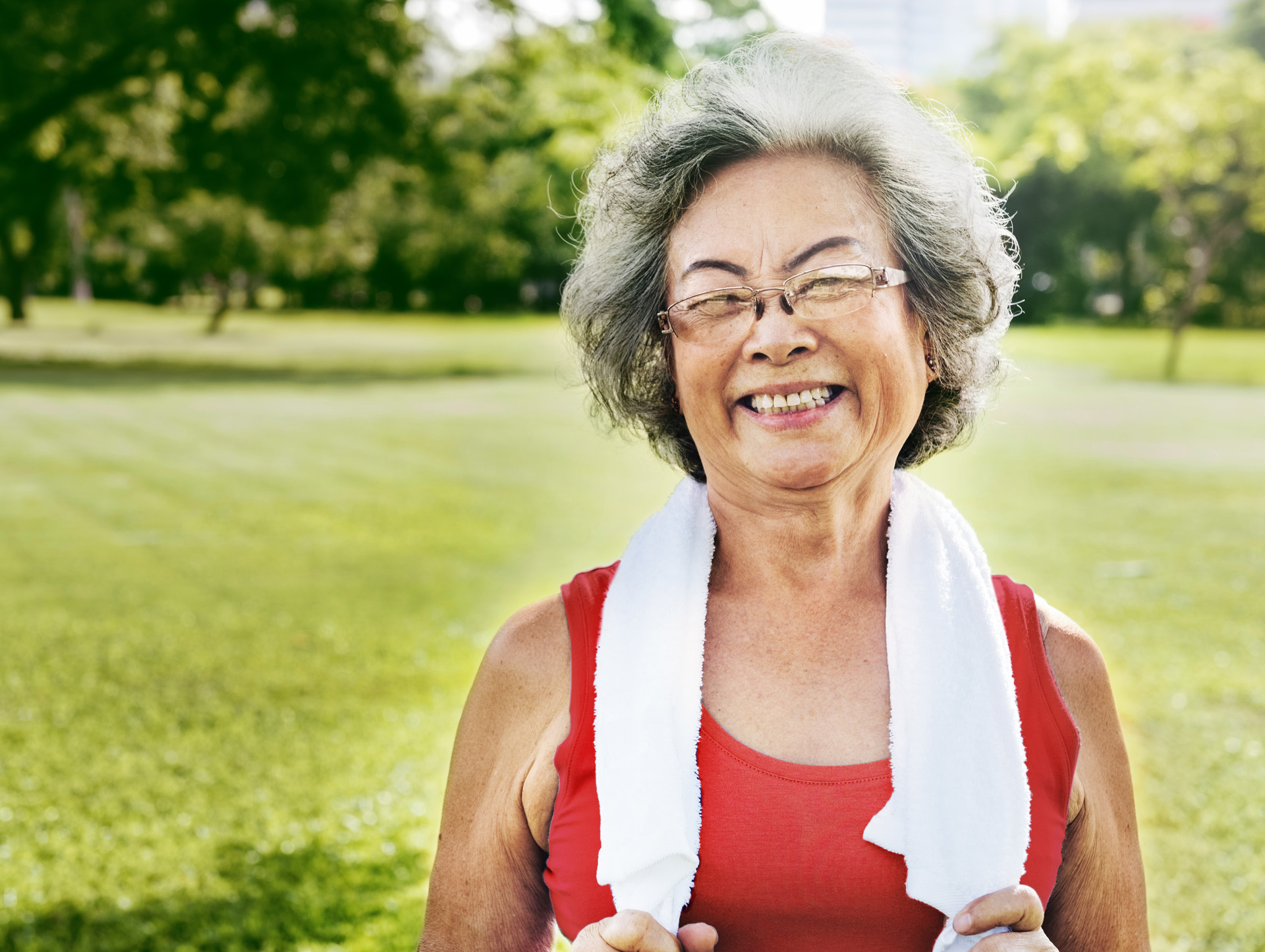 A senior woman exercising at a park
