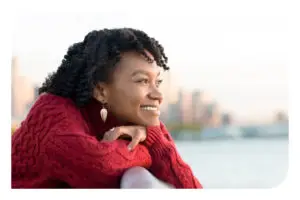 A woman smiling leaning on a railing
