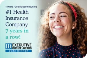 A woman smiling with IB Executive Choice Award - 2023 Winner icons in a teal banner