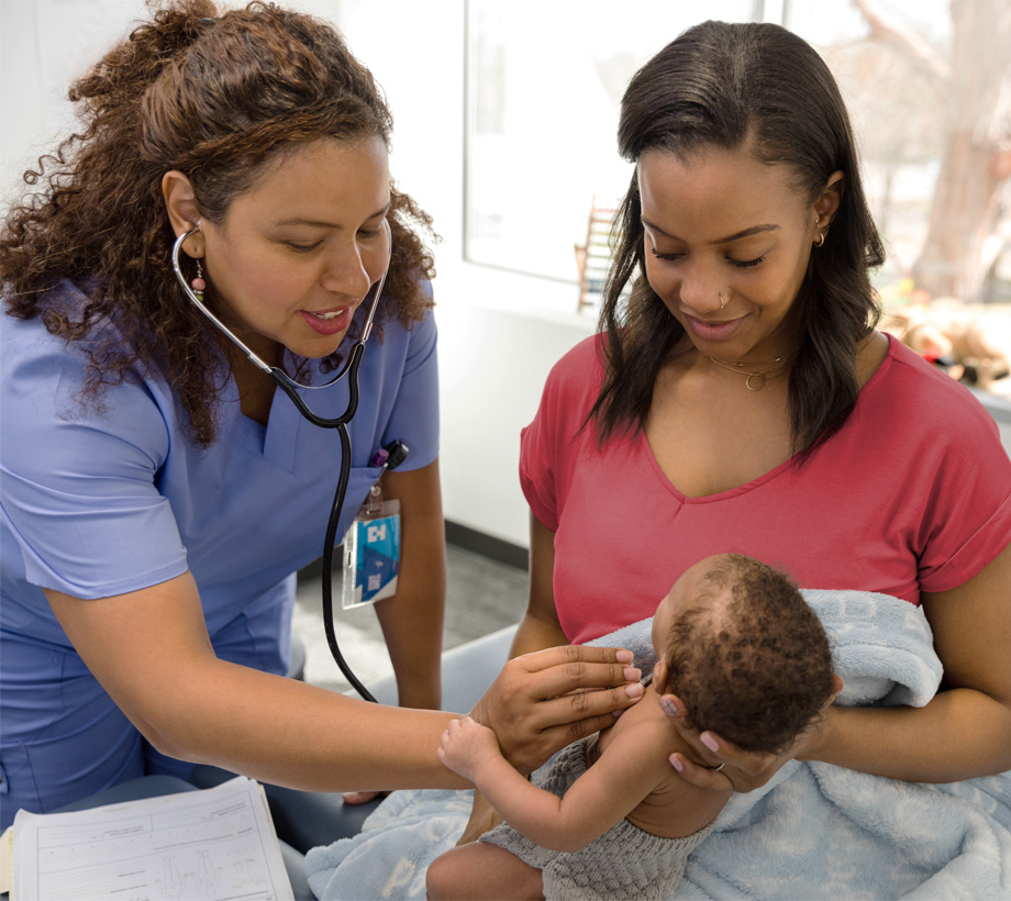 A healthcare professional preforming a check up on an infant