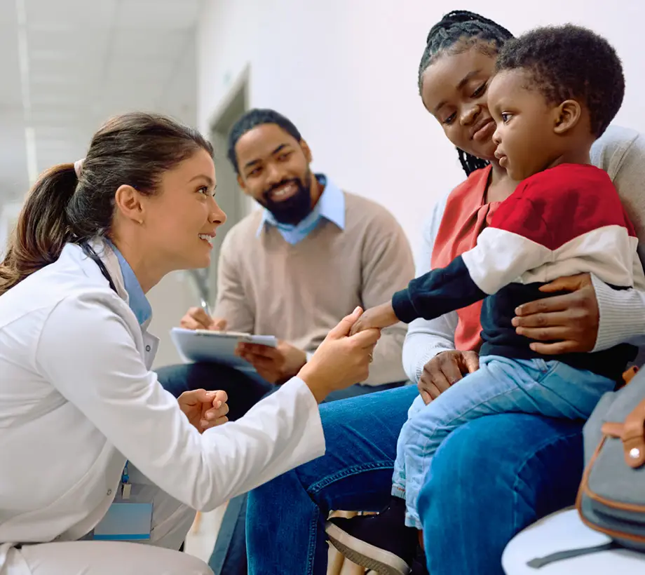 Healthcare professional performing a check up on a young boy.