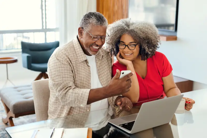 Feliz pareja de ancianos mirando un smartphone