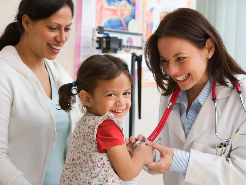 Doctor performing a check up on a young child