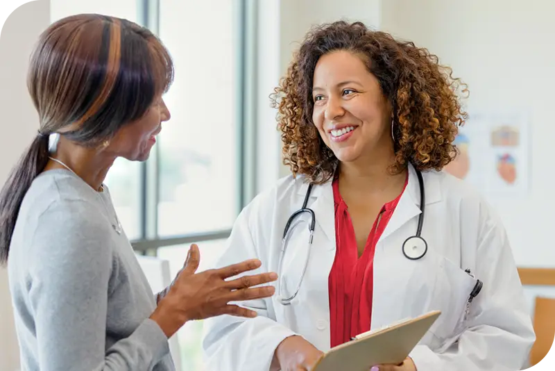 A health provider speaks with a patient