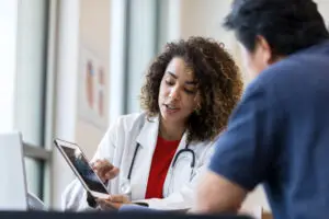 Female doctor showing information to a male patient