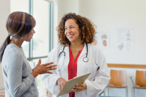 A provider smiles as they talk to a patient