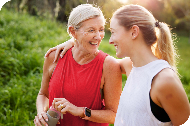 Mother and adult daughter on a walk together, laughing