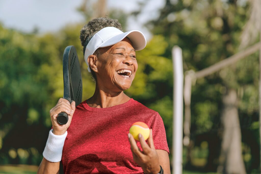 Portrait senior woman beach tennis
