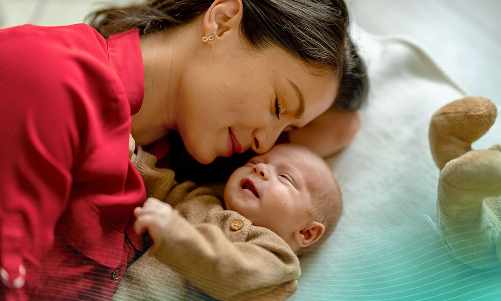 Young mother and baby napping at home