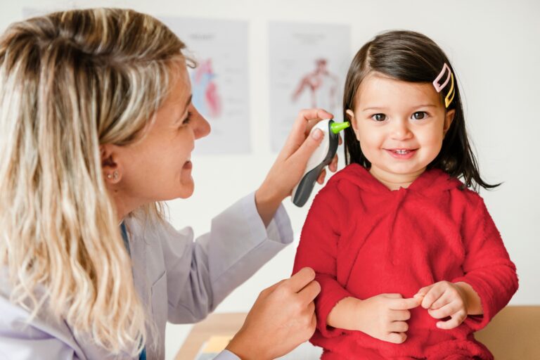 Otolaryngologist checking up on a sweet little girl
