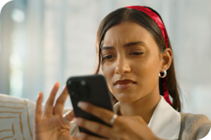 A woman looking at information on a cell phone