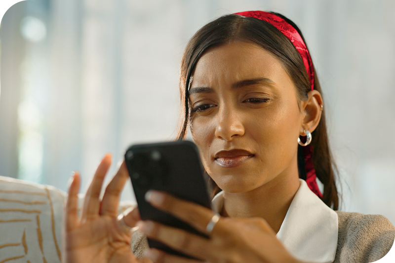 A woman looking at information on a cell phone